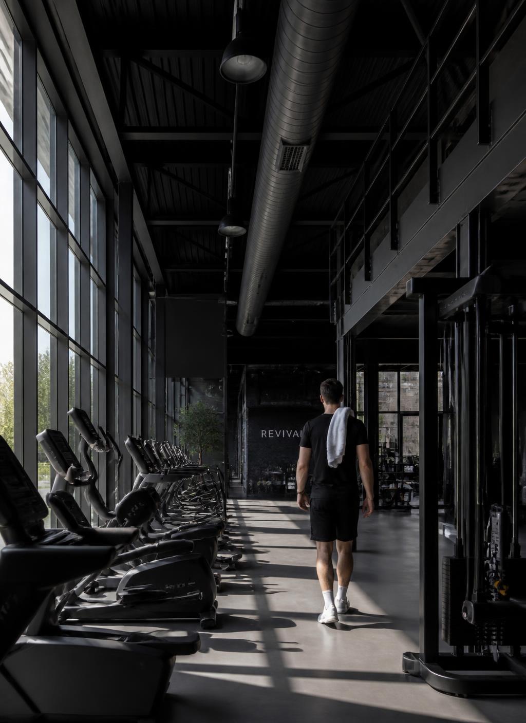 Corredor de equipamentos cardiovasculares da Pulse Fitness com luz natural